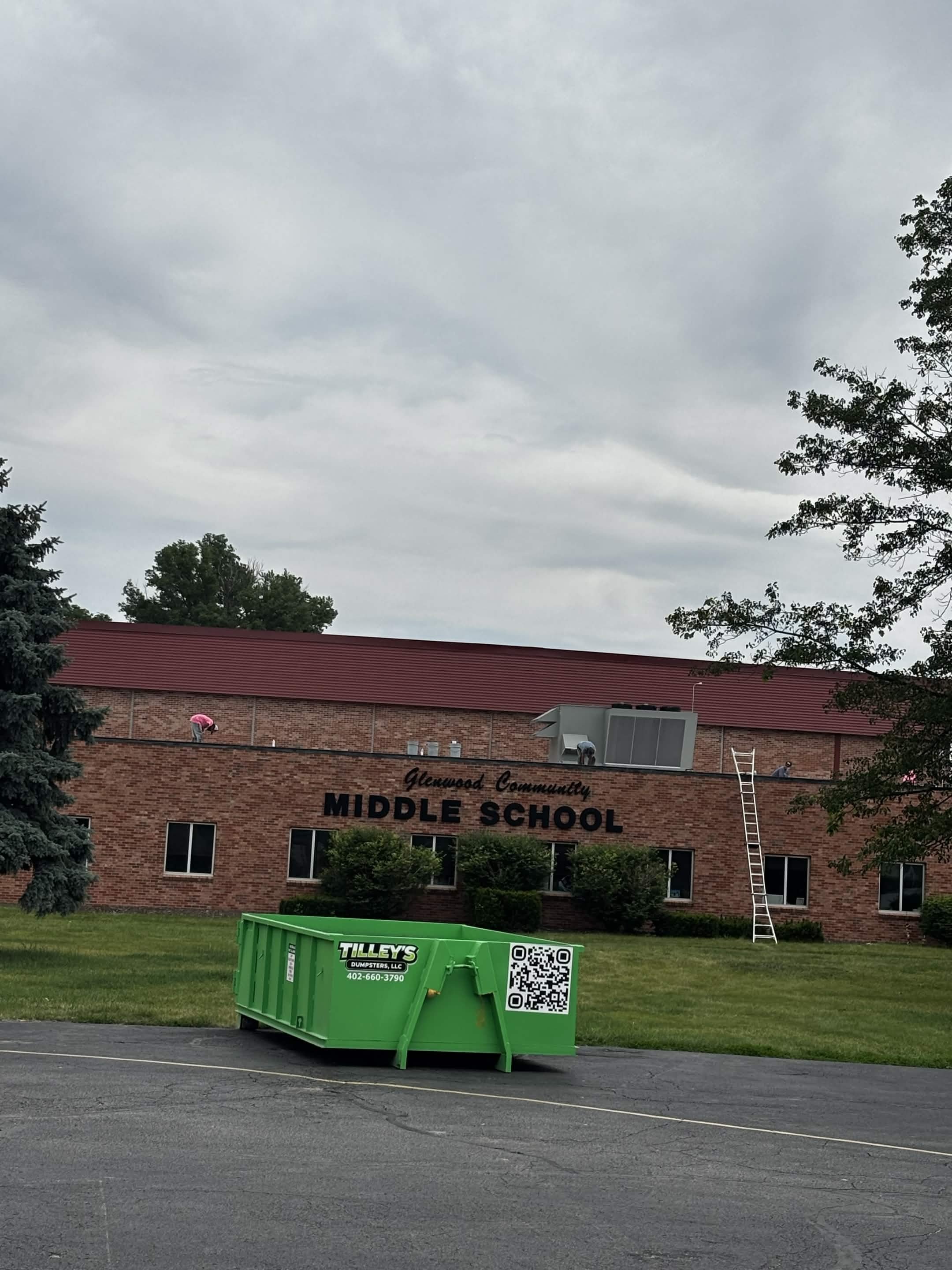Tilley's green roll-off dumpster in front of Glenwood Community Middle School in Glenwood, Iowa