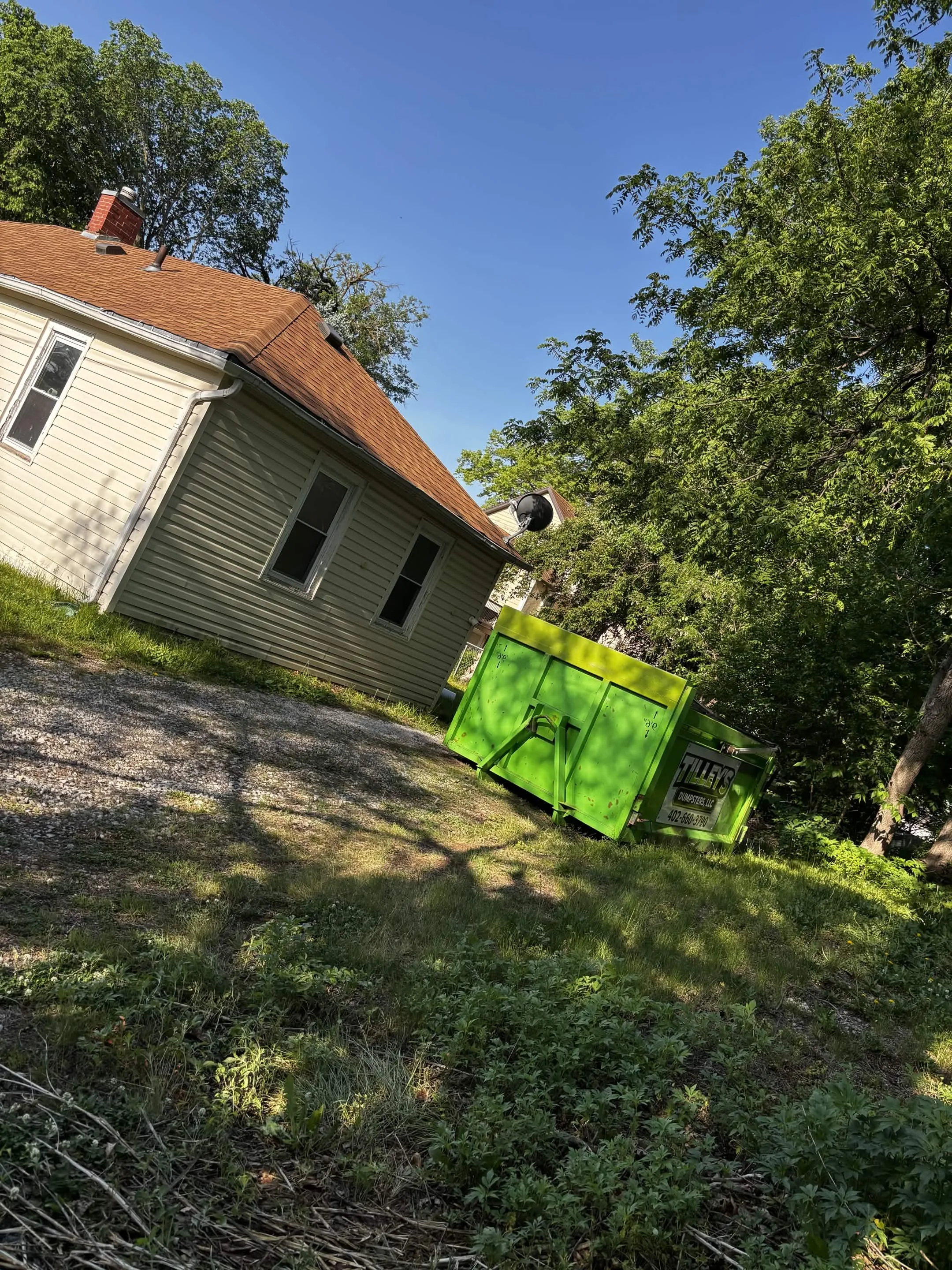 Tilley's dumpster on a hillside property